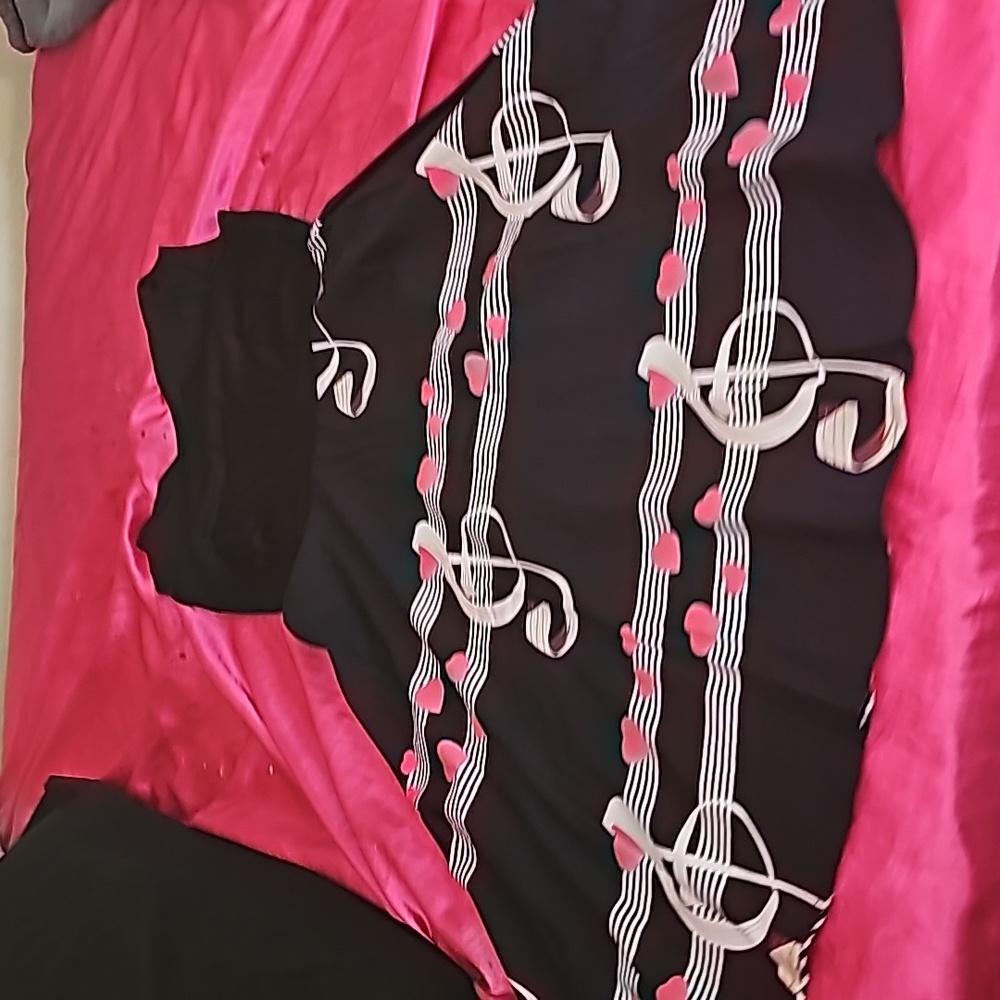 Never worn dress with hearts and musical notes.